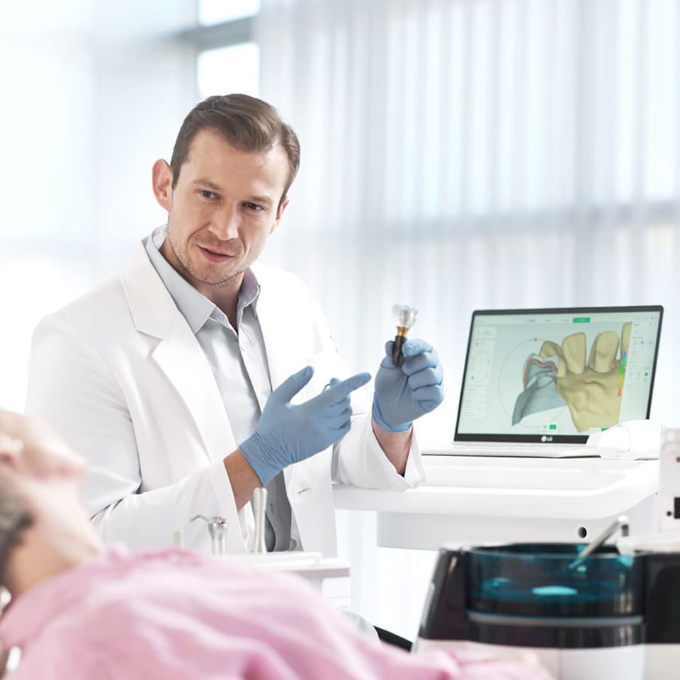 A dentist explaining implant treatment to a patient